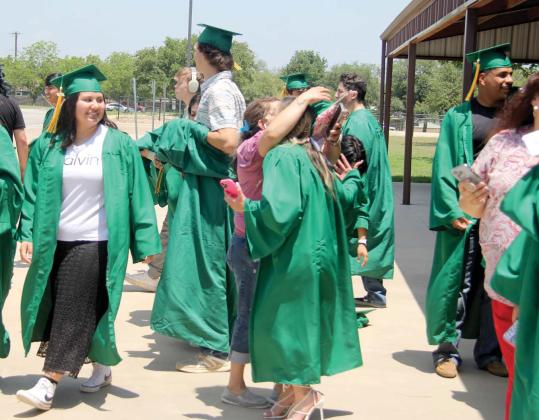 Parents and friends greet the seniors after they complete the walk in their caps and gowns at Dublin Elementary School Monday, May 8. Below, Dublin High School Principal Norma Briseno escorts the seniors into the school. Wyndi Veigel | Citizen staff photo