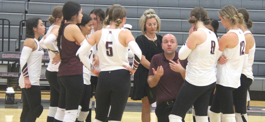 Lingleville head Volleyball Coach Brandon Haught and assistant coach Lauren Wilson huddle up with the team during the final home game Tuesday, Oct. 29. Paul Gaudette | Citizen staff photo