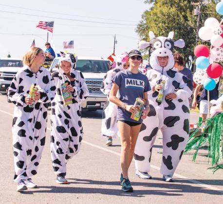 Dairy farm families and Schrieber employees say cheese as they march in the Stephenville July 4th parade downtown, celebrating their Red White and Moo pride in country and industry. Danielle Meador | Citizen staff photos