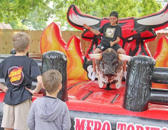 A young rider draws a crowd during the Saturday fundraiser for Revitalize Dublin as he tries to hold on to El Mero Mero Torito’s mechanical bull. Paul Gaudette | Citizen staff photo