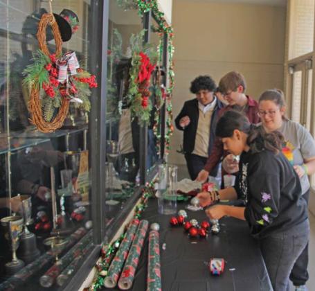 One Act Play students decorate the auditorium with Christmas decor in preparation of the upcoming Christmas Spectacular Tuesday, Dec. 17. Donations from the show help fund theatre department needs. Paul Gaudette | Citizen staff photo