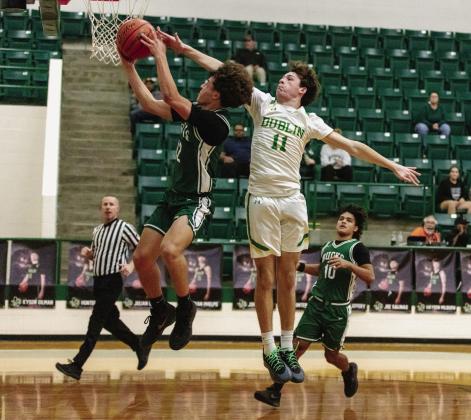 Dublin Lion Kyson Gilman goes airborne to block a Breckenridge shot during the Jan. 9 home game. Danielle Meador | Citizen staff photo