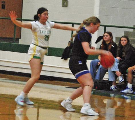 Lady Lion Savannah Chacon covers a Peaster ballcarrier in the Friday, Dec. 19 home game. Paul Gaudette | Citizen staff photo