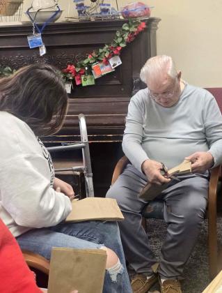 Three Oaks Assisted Living residents were joined in crafts and conversation Monday, Dec. 15 as Dublin High School Principles of Nursing students visited the facility for some festive fun. Activities included cutting out snowflakes and making reindeer gift bags. | Submitted photos