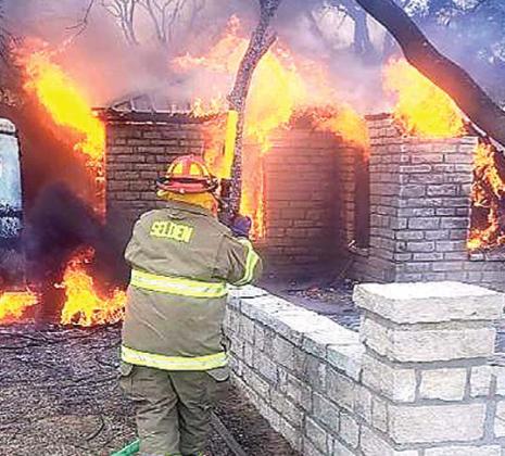 Members of the Selden Volunteer Fire Department work to combat a structure fire on County Road 209 near Duffau on Dec. 23. According to Erath County Fire Marshal Tommy Shelton, the cause of the fire in undetermined at this time. Submitted photo