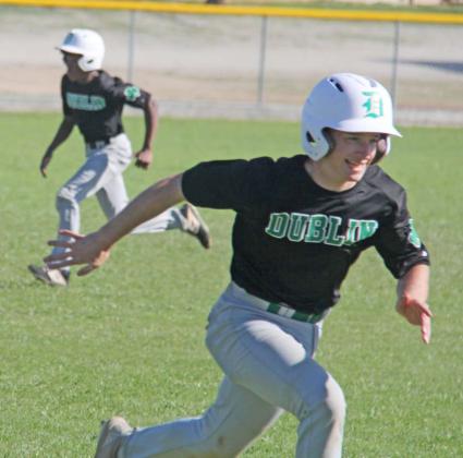 Dublin Lion Cameron Patton heads for home while Julian Calders sprints towards third in a recent away game. Paul Gaudette | Citizen staff photo