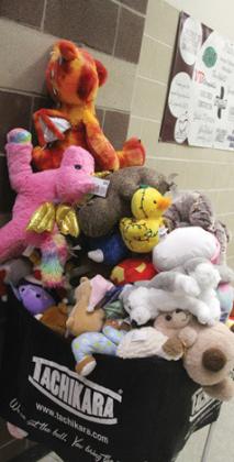 The Lingleville Cardinals got into the Christmas spirit Dec. 17 by warming up in ugly Christmas Sweaters before hosting a Teddy Bear Toss in which Gorman and Lingleville fans threw nearly 100 stuffed animals on to the gym floor. The toys were gathered up and delivered to Cooks Children’s Hospital by the Cardinals and Lady Cards. Paul Gaudette | Citizen staff photo