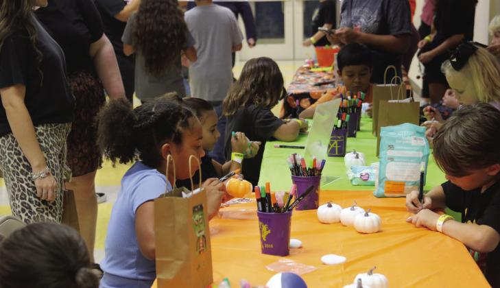 Despite rainy conditions outside, the Dublin PTO's annual Fall Fest went off without a hitch inside the Dublin Intermediate School Friday, Oct. 2. A wide variety of games including limbo were offered with candy, toys and stickers as prizes. Below, Cross Timbers Fine Arts Council offers kids the opportunity to color their own pumpkins. For more photos see The Dublin Citizen Facebook page. Wyndi Veigel-Gaudette | Citizen staff photo