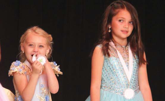 Little Miss Dublin contestant Sophia Beard puts her medal through a series of endurance tests as she waits for the winner to be announced alongside Lakyn Bamber. Paul Gaudette | Citizen staff photo