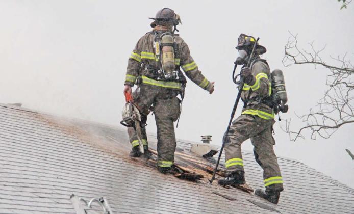 In a torrential downpour Thursday, April 24, Erath Fire/Rescue Firefighter Rocco Fitzgerald and Dublin VFD firefighter JW Brunson work to extinguish a house fire on Camden Street in Dublin. The cause of the fire is undetermined at this time. Dublin VFD, Erath Fire/Rescue, Harbin VFD, Erath County Fire Marshal Tommy Shelton and Dublin PD aided at the scene. The home suffered serious damage but no one was injured. Wyndi Veigel-Gaudette | Citizen staff photo