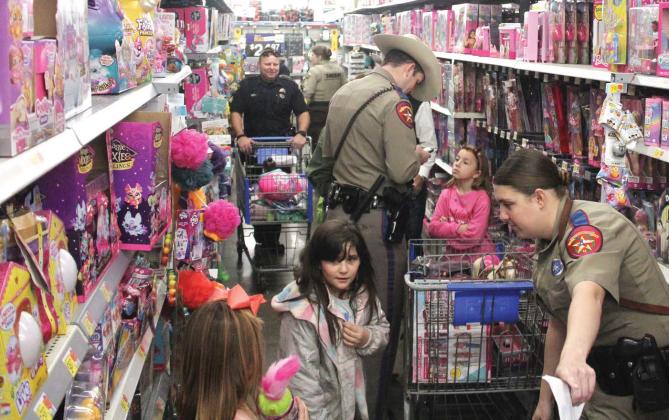 The Barbie aisle at Walmart was extremely busy during the fourth annual Shop with a Cop for Erath County, as law enforcement and kids chose their Christmas gifts. Wyndi Veigel-Gaudette | Citizen staff photo