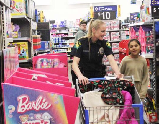 School Resource Officer Brandi Hoffman helps a young lady shop for Christmas presents during Erath County’s Shop with a Cop event Thursday, Dec. 21 at Walmart. For more photos see the Dublin Citizen Facebook page. Wyndi Veigel-Gaudette | Citizen staff photo