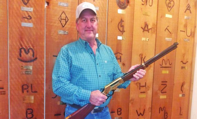 Raffle winner accepts rifle