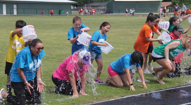 Wyndi Veigel | Citizen staff photo Teachers and administrators ‘enjoy’ a nice ice bath Wednesday, May 17 at the Dublin Elementary School Field Day. All third grade students who were present during STAAR testing were entered into a raffle to be able to douse the educators with ice cold water. From left is Elementary School Principal Kalley Mitchell and teachers De’Ann Bradford, Jessica Criswell and Leslee Chapman.