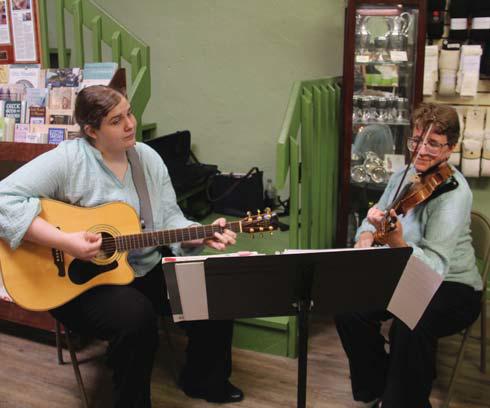 Christine and Robin Anderson play Celtic music inside Things Celtic Saturday, June 8 to entertain reunion shoppers as they enjoyed downtown. Wyndi Veigel-Gaudette | Citizen staff photo