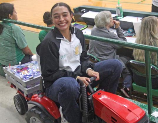 Above, Seniors NavaLee White and Emma Vargas pause from traversing school with their belongings in a remote control car for ‘Anything but a Backpack’ Day Friday, Aug. 30 at Dublin High School. Students are encouraged to carry their belongings in anything ... other than a backpack. Below, Junior Olivia Salyer transports her supplies on a mini tractor. Paul Gaudette | Citizen staff photo