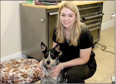 Kynlee Winkelman recently opened Hound Town Grooming Spaw in Dublin. She is accompanied by her dog, Cinch. Wyndi Veigel | Citizen staff photo
