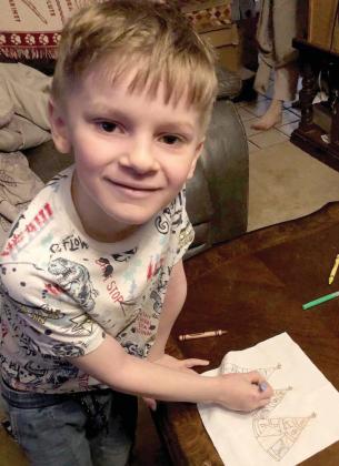 Jackson Stover, youngest member of the Bosque River Chapter of CRT, prepares his quilt block. Submitted photo