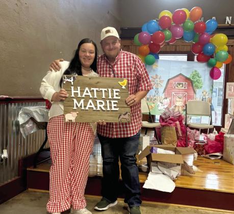 Aubrey and Fredrick Broadbent celebrate the expected birth of their daughter Hattie Marie at their shower. The couple's home, and their nursery items, suffered significant damage after a fire started from lightning during the May 10 storms. Left, damage to their home is shown. Courtesy photo