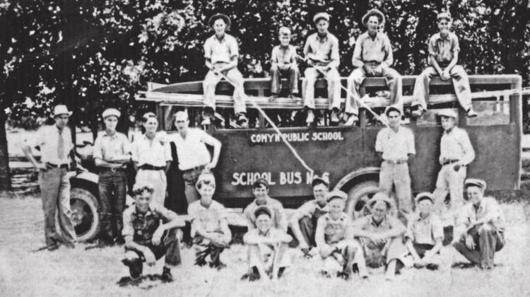 This group of students above was probably on a fund raising trip, harvesting pecans with the cane poles. Comyn was one of the first schools in Texas to have motorized school buses. Motorized buses allowed the State of Texas to close smaller schools and send students to schools with better facilities. Comyn had a rock school (right) that was very nice for a community of its size. This picture was probably taken in the 1930s. | Citizen staff photo