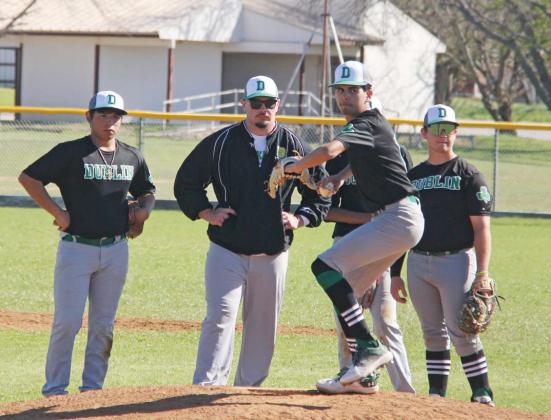 Dublin Lions and assistant coach Dalton Soullas spots for Kaden Gaitan as he warms up to pitch during the DeLeon tournament game against Goldthwaite on Saturday, March 9. Paul Gaudette | Citizen staff photo