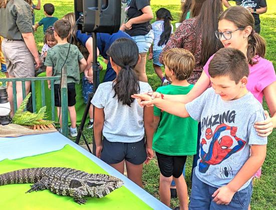 A sister attempts to get her brother to touch Tina the Tegu, a lizard from Argentina, at the Creature Teacher presentation at the Dublin Public Library Thursday, June 8. All kinds of animal knowledge, along with interactions were presented at the program. See more photos of the presentation on the Dublin Citizen Facebook page. Paul Gaudette | Citizen staff photo