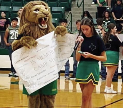 DHS Cheerleaders sport shirts designed by senior Emma Mitchell as part of a fundraiser for Camp Mystic in Kerrville which flooded on July 4. Mitchell (below) addressed the crowd during the Sept. 5 pep rally. | Submitted photo