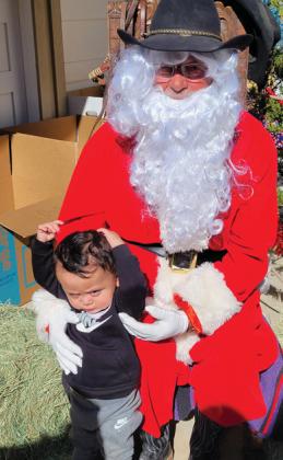A kid isn’t such a fan of Cowboy Santa, showing off his grumpy face at the Cowboy Christmas event in downtown Dublin. Wyndi Veigel-Gaudette | Citizen staff photo