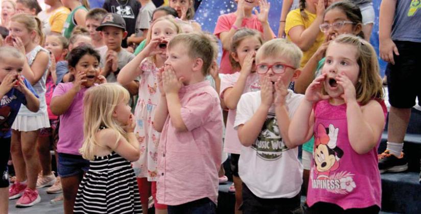 Kids at First Baptist Church’s Vacation Bible School participated in a ‘Stellar’ experience over July 10-12. Below inset, puppets Mickey and Roxanne teach Biblical lessons to children. The puppets were played by Caitlin Silva (below, right) and Mikayla Taff. Mikayla received a pie in the face after ‘losing’ to Caitlin whose bucket had the most weight in coins collected for local mission work. Mikayla’s bucket had 4.6 pounds and Caitlin’s bucket had 29 pounds. Wyndi Veigel | Citizen staff photo