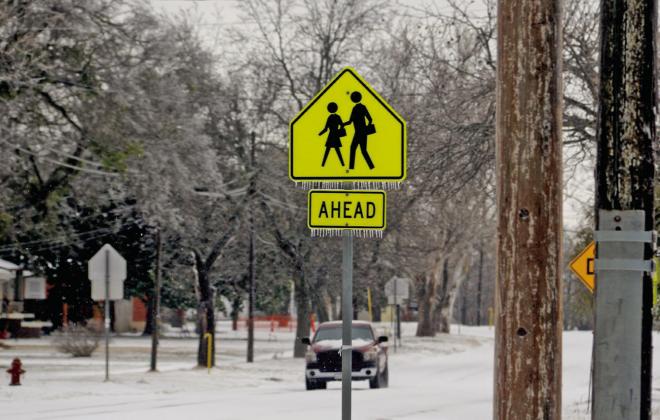 Icicles freeze on a school crossing sign during Winter Storm Fern. School was canceled for numerous days because of the inclement weather. Paul Gaudette | Citizen staff photo