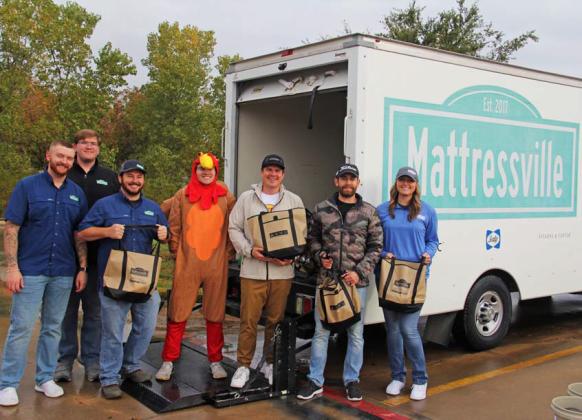 Mattressville employees and volunteers gather turkeys to hand out to citizens at their annual turkey giveaway for Thanksgiving at BMY in Stephenville. Up to 1,200 pounds of the birds were provided by sponsors of the event including Mattressville, BMY Wealth Management Group and Bar Diamond Inc. Paul Gaudette | Citizen staff photo