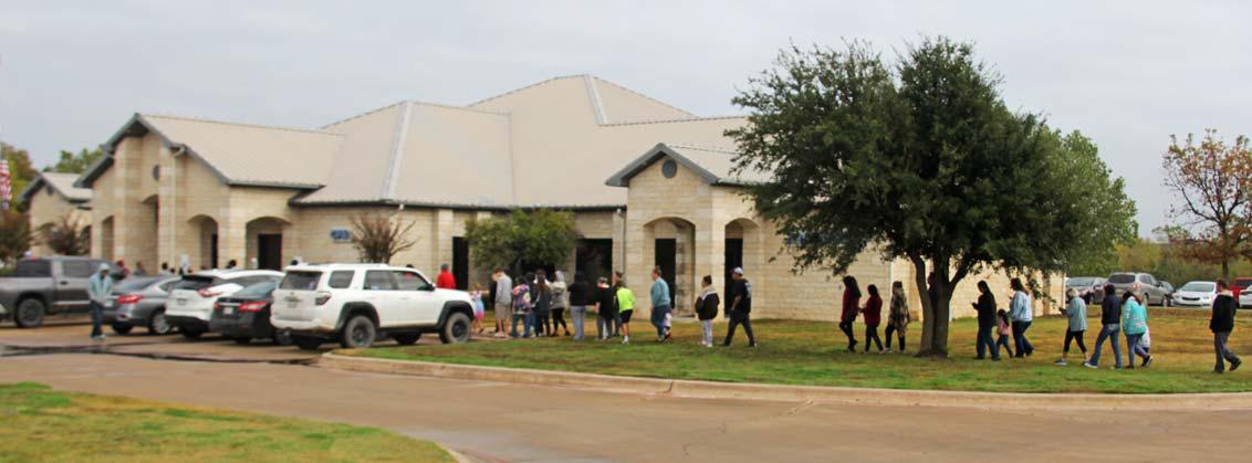 Citizens wait in a line outside BMY Wealth Management Group in Stephenville to collect their free turkey. Paul Gaudette | Citizen staff photo
