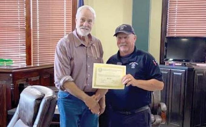 Emergency Medical Services Director Cary Jackson receives a 5-year service award from the county presented by Commissioner Ray. Submitted photo