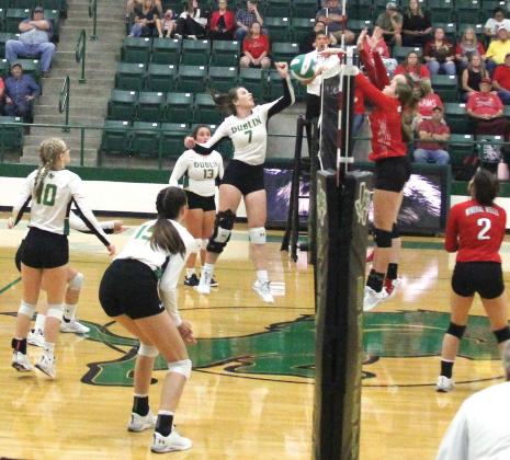 Dublin Lady Lion Madison Turley leaps to meet a Mineral Wells Ram at the net in an Aug. 16 home game.