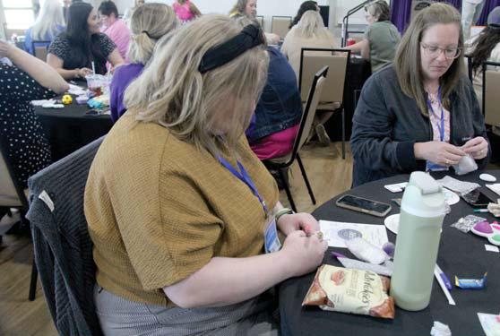 An individual decorates a ‘resiliency’ stone to help remember steps for self care at the summit. Wyndi Veigel-Gaudette | Citizen staff photo