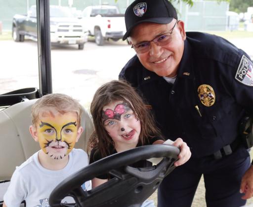Stephenville’s City Park was packed last week as crowds’ celebrated Erath County’s ties and rich history with the dairy industry at the annual Moo-La Fest. Live music (above) draws spectators to the Birdsong Amphiteater while younger guests get in the spirit (left) by dancing the Macarena. Some freshly painted faces take in some shade in a police cart (below) while a musician shows off his style on strings (below, left). David Swearingen | Citizen staff photos