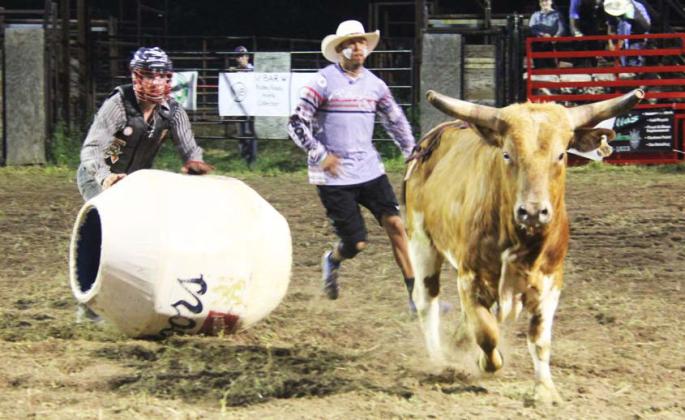 Bullfighters and rodeo clowns worked to get bulls penned again after they shed their riders (below). The rodeo staged by Lilly G Arena Productions also benefited Dublin’s CWJC Transformation Pathway ministry.