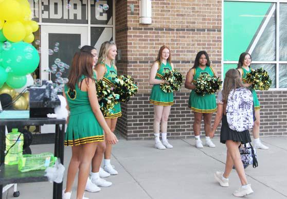 Clockwise from top left, an excited student gets ready for the first day at Dublin Elementary. Varsity Cheerleaders greet a pre-K student. A young student models a Barbie shirt for first day photos. Varsity Cheerleaders welcome in students at the Dublin Intermediate School amid a sea of bubbles. Wyndi Veigel | Citizen staff photos