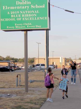 An excited student skips his way down the sidewalk while carrying his nap mat and waiting for the rest of his family to catch up on the first day of school for Dublin ISD. For more photos see the Dublin Citizen Facebook page. Wyndi Veigel | Citizen staff photo