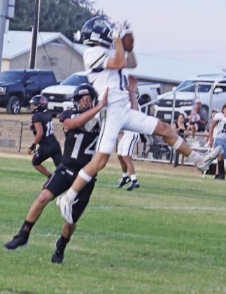 Lingleville Cardinal Klayson Guajardo snags a Perrin-Whitt Pirate in midair (above) during the home game Friday, Sept. 4 while teammate Jacob Koke (above right) gets met by a trio of defenders rushing the ball up field. Cheerleaders spin and shout keeping up the excitement. In the end, the Pirates won 51-6. Paul Gaudette | Citizen staff photo