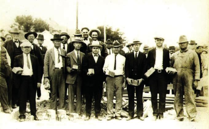 Mayor David Leatherwood and city councilmembers along with city staff and EDC members hold Thurber bricks in a re-creation photo from the groundbreaking of when Dublin first paved downtown May 12, 1926. Both photos were taken at the corner of Live Oak and Patrick Street. A ceremony is being held at 2 p.m. Saturday, May 9 at the Dublin Historical Museum in downtown. Paul Gaudette | Citizen staff photo