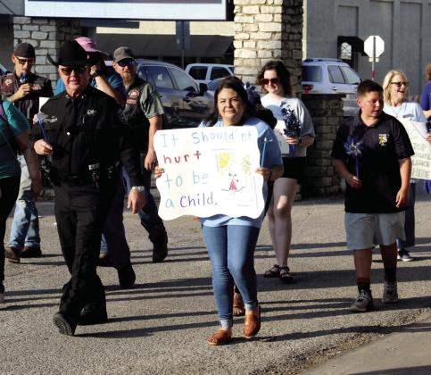 Dublin School Resource Officer Jacob Carpenter, left above, walks with supporters in solidarity against violent crimes at the annual Stop the Silence Rally organized by Cross Timbers Family Services. Above right, Tarleton Police Chief Matt Welch walks in solidarity against child abuse. For more photos see the Dublin Citizen Facebook page. Wyndi Veigel-Gaudette | Citizen staff photo