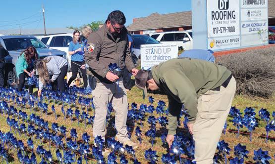 Sheriff deputies plant pinwheels along with other law enforcement departments for Child Abuse Prevention Month. Wyndi Veigel-Gaudette | Citizen staff photo