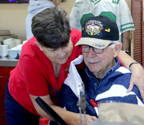 Robert Earl is wrapped in his Quilt of Valor in a presentation honoring his military service Saturday, May 2 at Granny Clark's. Wyndi Veigel- Gaudette | Citizen staff photo