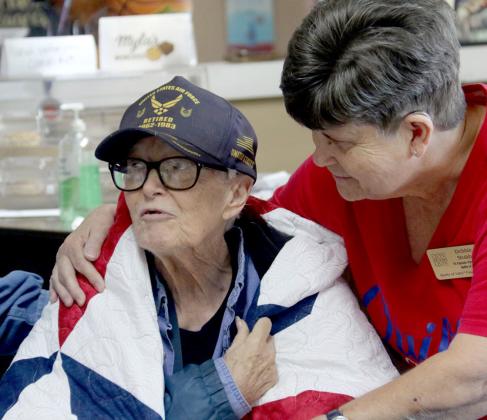 Veteran Sandra Cullipher is wrapped in a handmade quilt given as a form of a lasting hug from representatives with the Quilts of Valor. Wyndi Veigel-Gaudette | Citizen staff photo
