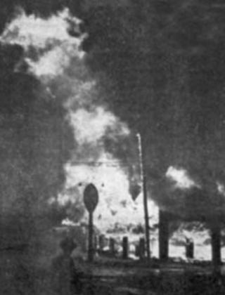 The Red Front (above) was a red brick building that was located at the corner of Patrick St. and Elm. The Texaco station was a popular place to get gasoline and provided employment for local teenagers who needed a job. On the night of the fire (right), both brick walls facing Patrick and Elm collapsed. The Texaco sign is in the foreground with the raging fire behind Hisorical Museum | Submitted photos