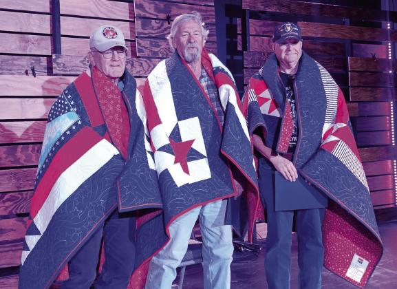 From left, veterans Carroll Cawyer, Bruce Delater and Vince Parro are awarded Quilts of Valor from the Cross Timbers Republican Women’s Club at the annual Veterans Day lunch held Tuesday, Nov. 11 sponsored by White Horse Academy. The handmade quilts are awarded to a service member or veteran who has been touched by war. The quilt says unequivocally, “Thank you for your service and sacrifice in serving our nation.” Courtesy photo