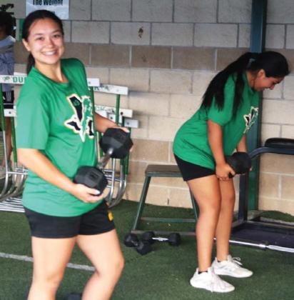Dublin Volleyball Lady Lion Haden Keilers (below) shows that the weight exercises are no sweat Monday, Aug. 4 as the team had to switch up its schedule due to stormy weather that morning. Head coach Hannah Smith shows proper exercise form (at right) with the assistance of Olivia Salyer. The team started practice Aug. 1 in prep for scrimmages and games starting in the next week. See Sports schedule on page A12. Paul Gaudette | Citizen staff photo
