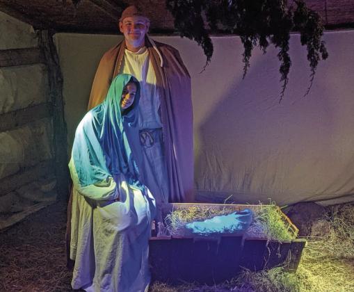 Mary and Joseph comfort Jesus in Bethlehem, a live walk-through experience organized by Lingleville Baptist Church Dec. 12-14. Paul Gaudette | Citizen staff photo