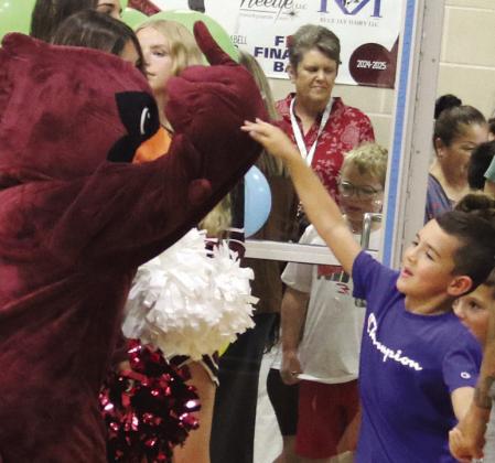 Lingleville ISD was abuzz with parents and kids for Meet the Teacher Night Aug. 6. Interim principal Alexa Garrison takes signatures for a backpack raffle while a young student high fives the mascot. Citizen staff photos Paul Gaudette |